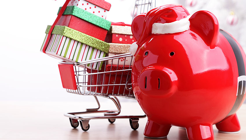 Santa Claus style piggy bank with a mini shopping cart filled with gifts