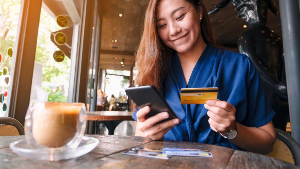 Benefits of banking locally, woman with debit card