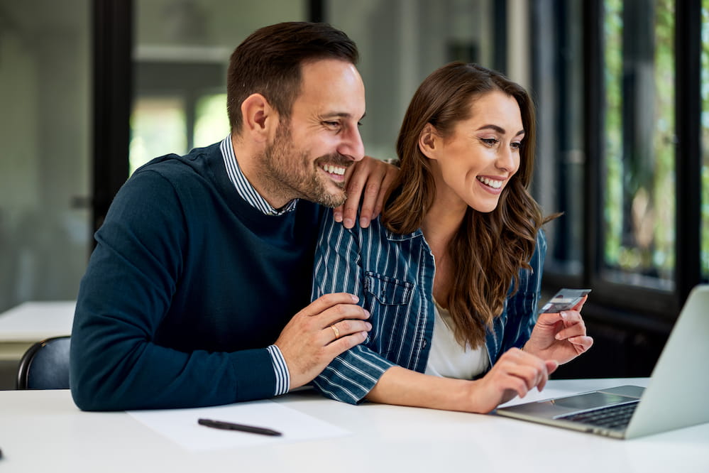 Young couple looking at best checking account features